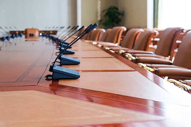 conference table with group of microphones before conference.